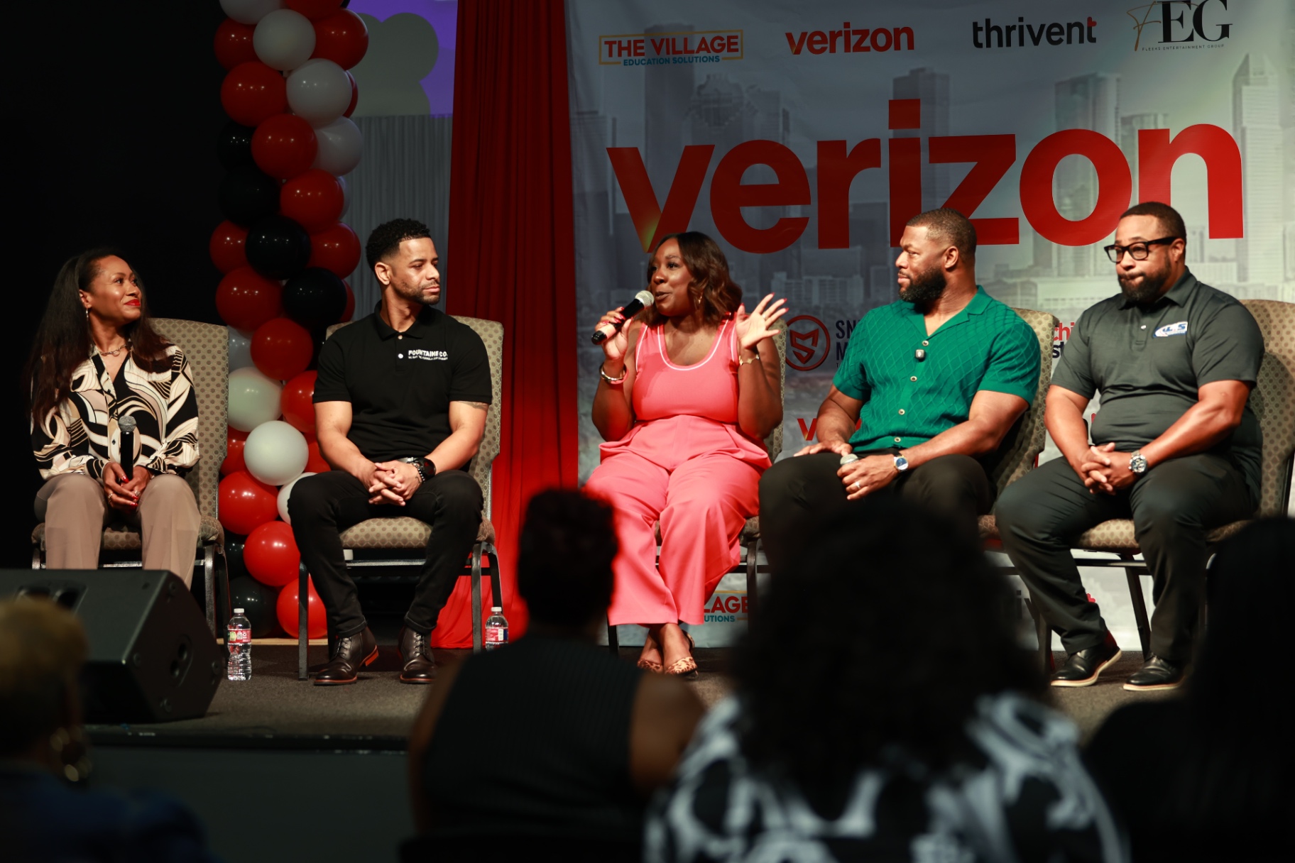 Panel of speakers on stage at the Verizon Selfmade Houston Experience with Verizon branding
