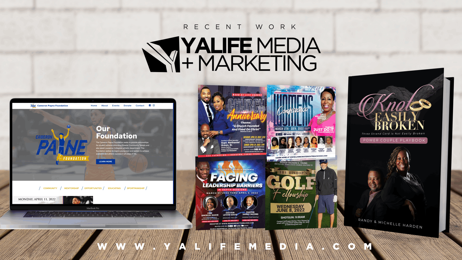 Laptop showing the Cameron Payne Foundation website beside church flyers and a book cover